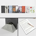 Stack of books magazines open notebook with handwritten notes stationery items and photo frames on desk