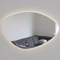 Oval Mirror with Lighted Edge Reflecting Gray Sofa and Pillows in White Wall Interior