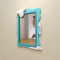 Blue Frame Mirror With Melted Cream Effect Reflecting Bed Pillows And Quilt On Beige Wall