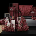 Elegant Wedding Stage Setup With Red Curtains Floral Arrangements And Chandeliers