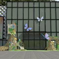 Spring Themed Floral Display With Butterfly Archway Green Plants And Decor