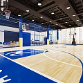 Indoor Basketball Court with Wooden Floor Basketball Hoops Overhead Lighting Net Partitions and Large Windows