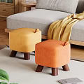 Cozy Living Room With Yellow And Orange Woven Fabric Stools With Wooden Legs