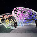 Modern Unique Pergola with Colorful Lights at Night Under Starry Sky People Interacting Around