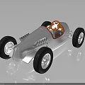 Vintage Silver Race Car With Orange Steering Wheel And Black Tires