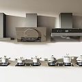 Modern Kitchen Appliances Featuring Range Hoods And Stovetops With Pots