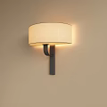 Elegant Wall Lamp with Beige Fabric Shade and Black Metal Bracket on Light Wall