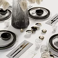 Modern Tableware Set With Black Plates Bowls Transparent Glassware Silver Cutlery And White Floral Arrangement