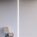 Minimalist Single Chair With Linen Upholstery Design In Modern Living Room Against Wall