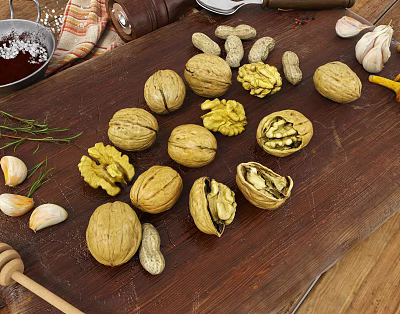 Walnuts Peanuts And Garlic Arranged On Wooden Cutting Board With Rosemary Honey Salt And Pepper 3d model