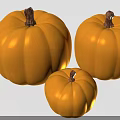 Three Fresh Ripe Yellow Pumpkins in Different Sizes as Nutritious Crop