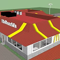 Commercial Complex Featuring McDonald's Restaurant With Red Roof Yellow Signage White Fence And Red Umbrellas