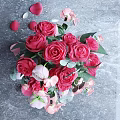 Transparent Glass Vase With Red Pink Roses Green Leaves And Petals On Wooden Table