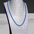 Turquoise Beaded Jewelry Necklace Display on White Mannequin with Marble Surface