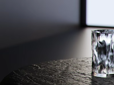 Transparent Glass Cup With Irregular Patterns On Dark Textured Table Near Window Light 3d model