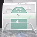 Dr.DH Skincare Brand Modern Reception Desk With Stylish Green And White Design And Products On Shelves