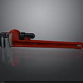 Red Pipe Wrench Tool Placed On Black Reflective Surface Background