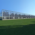 Modern Industrial Factory Exterior With Large Glass Curtain Walls Metal Frames And Green Lawn