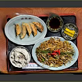 Traditional Asian Food Platter with Dumplings Noodles Rice and Sauce on Wooden Tray