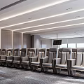 Modern Large Conference Room With Multiple Rows Of Gray Seats Lighting And Wall Design