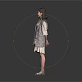 Smiling Woman In Gray Plaid Coat And White Dress Standing Against Gray Background