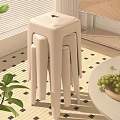 Minimalist Stackable Beige Stools in Modern Home Interior with Round Table Green Plants and Grapes