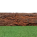 Ancient Weathered Scenic Wall with Orange Gray Bricks in Green Grass Field and Blue Sky