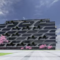 Modern Architectural Building With Unique Curved Glass Facade And Pink Flowering Trees