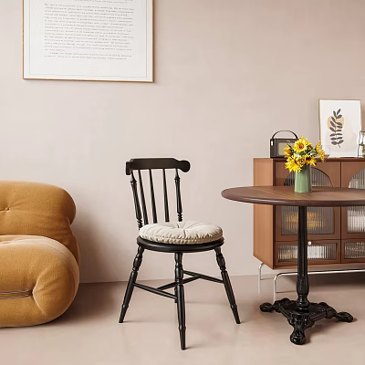 Comfortable Black Accent Chair With Beige Padded Seat Next To Brown Sofa And Wall Art 3d model