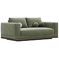 Green Velvet Two Seater Sofa With Round Pillows And Dark Wooden Base