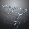 Shiny Blue Rosary Beads With Silver Cross Pendant On Dark Surface
