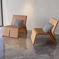 Brown Curved Design Leisure Chairs With Black And White Check Pillows In Modern Bright Room