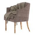 Gray Armchair With Black And White Herringbone Blanket And Wooden Legs