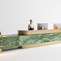 Hotel Front Desk With Green Marble Countertop Gold Accents Two Computer Monitors And Staff Member