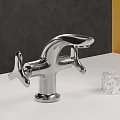 Modern Chrome Faucet on White Countertop with Marble Cube Against Dark Gray and Yellow Wall