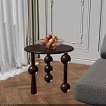 Dark Brown Wooden Side Table with Three Spherical Legs and Fruit Bowl Holding Fresh Fruits