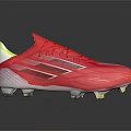 Red Athletic Soccer Shoes With White And Yellow Accents And Spiked Soles