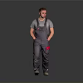 Male Worker In Gray Overalls With Red Pockets Standing On Gray Background
