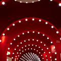 Red Arched Tunnel Interior With White Circular Lights Gray Floor And ICE Sign At End