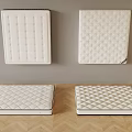 Various Quilted Mattress Designs Displayed On Wall And Wooden Floor