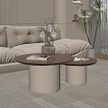 Beige Sofa With Two Round Coffee Tables Wooden Tabletop White Cylindrical Base And Magazines