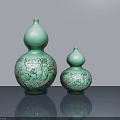 Two Green Gourd Shaped Ceramic Sculptures With Intricate Carved Patterns On Table 3d model