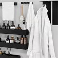 Organized Bathroom Essentials With Storage Shelves Towels Robe Bottles And Toiletries