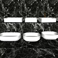 Three Elegant Modern White Washbasins on Black Marble Bathroom Countertop
