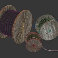 Wooden Cable Reels With Black Cables In Various Sizes On Dark Background