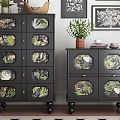 Black Plant Patterned Chest of Drawers With Potted Plants And Framed Artworks