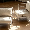 Elegant Modern Armchair With Metal Frame Beige Cushion And Sunlit Wooden Floor