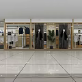 Modern Clothing Store With Glass Display Windows Mannequins Clothing Racks And Green Plants