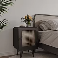 Dark Rattan Panel Bedside Table With Vase Flowers And Cup In Bedroom