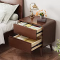 Wooden Nightstand With Open Drawers Containing Books And Table Lamp With Flower Pot
